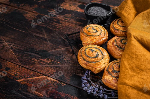 Preview: Sweet roll poppy seed buns with lavender ready for cooking. Wooden background. Top view. Copy space