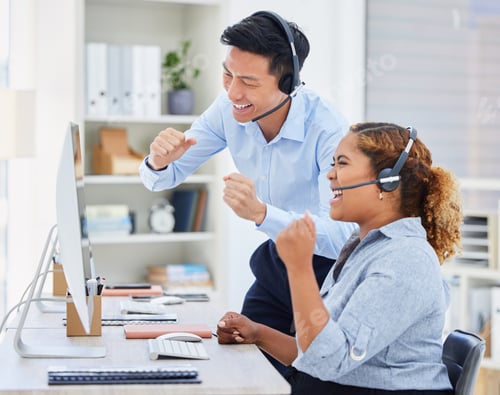 Preview: Two happy young diverse call centre telemarketing agent cheering with joy and punching the air with
