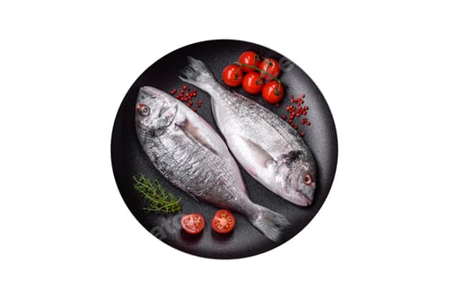 Preview: Fresh raw dorada fish with salt, spices and herbs