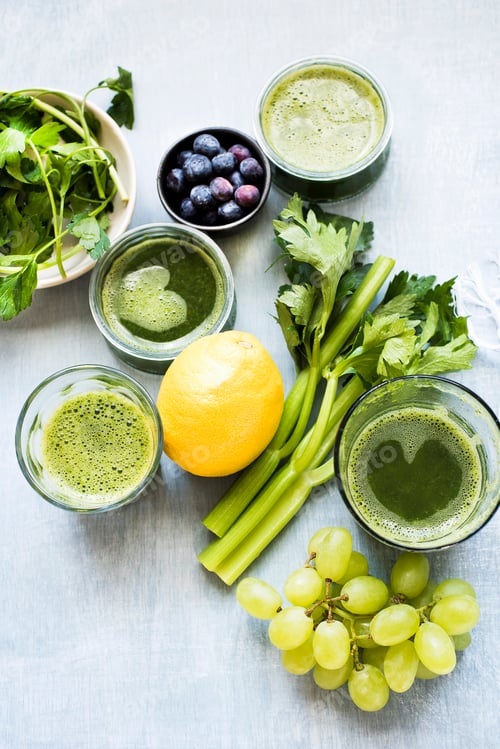 Preview: Healthy green smoothie with fresh fruits and vegetables on a light wooden background
