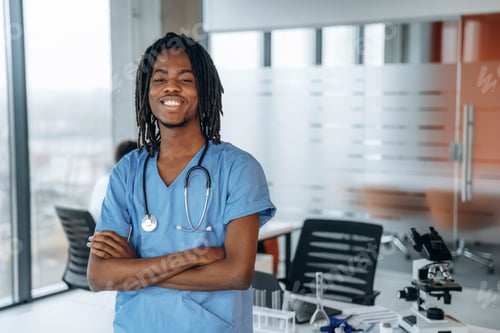 Preview: Standing and smiling. Black man doctor is in the office