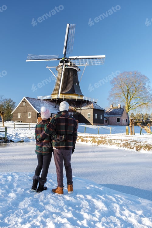 Preview: A Couple of men and women walking in the snow during a cold winter day in the Netherlands