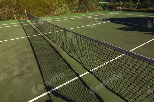 Preview: General view of tennis court and tennis net on sunny day