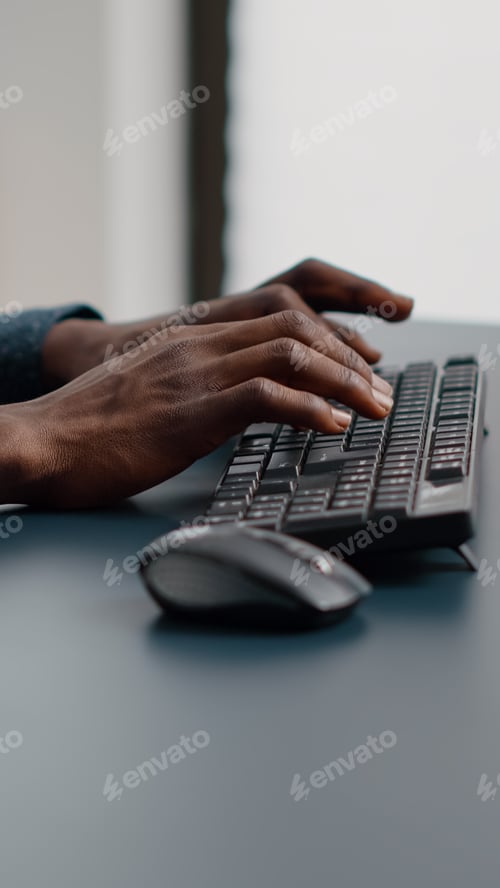 Preview: Close up of african american man hands typing on computer keyboard