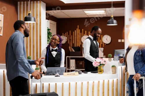 Preview: Hotel worker greeting guest at reception
