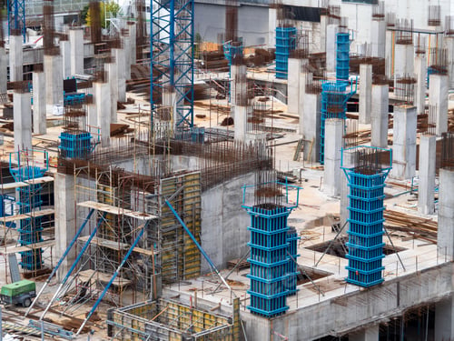 Preview: Urban construction site with concrete pillars and formwork.