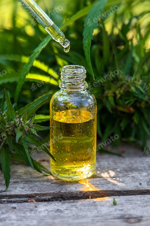 Preview: Hemp essential oil in a bottle. selective focus.