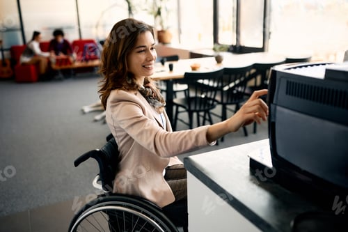 Preview: Happy businesswoman with disability using coffee machine in the office.