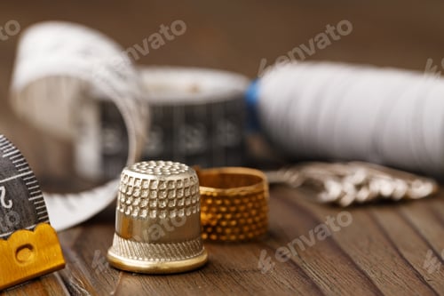 Preview: Threads and sewing accessories on brown wooden table