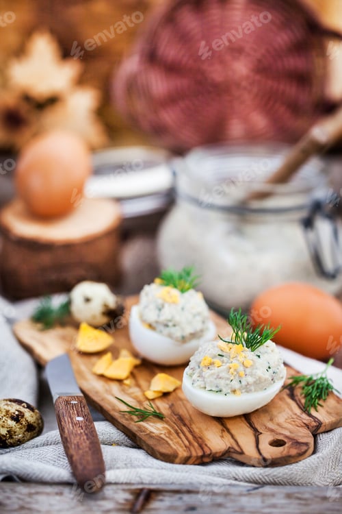 Preview: Eggs stuffed with herring creamy pate on wooden rustic backgroun