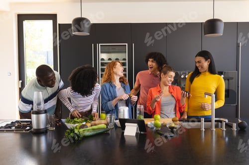 Preview: Happy diverse friends cooking together and smiling in kitchen