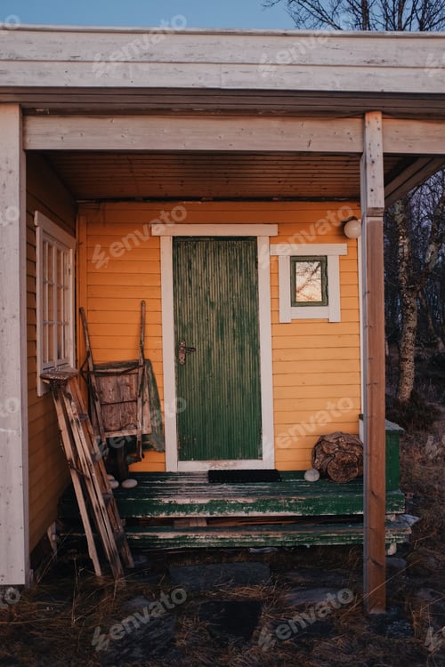 Preview: yellow wooden cabin in a sunset light