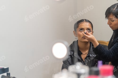 Preview: Professional make up artist applying eyeshadow on a client in a beauty salon