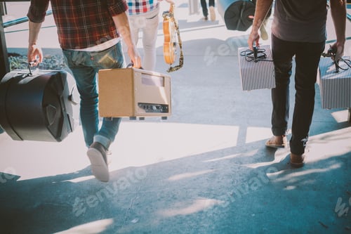 Preview: Friends Carrying Musical Equipment on Bright Day