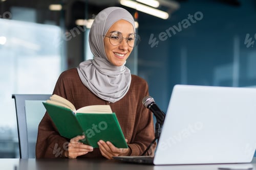 Preview: Young beautiful muslim woman in hijab working in modern office using professional microphone to