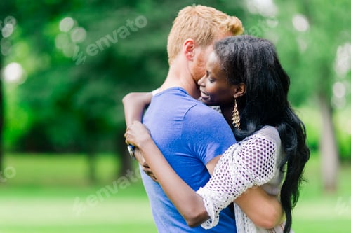 Preview: Couple in love hugging and kissing peacfully outdoors