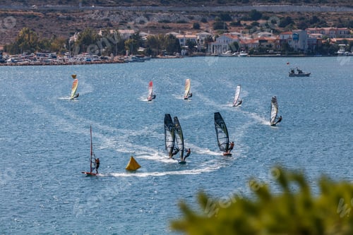 Preview: Alacati, Turkey. Colorful windsurfers on a windy day