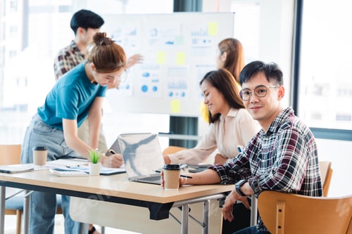 Preview: group of happy business people during presentation Colleagues look at the camera and smile.