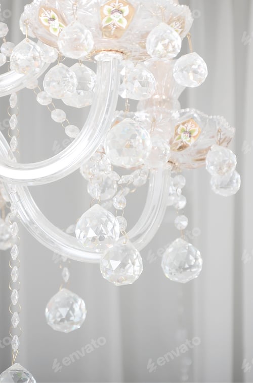 Preview: Close-up photo of the scenery on the old chandelier. Glass figures shine and reflect light with