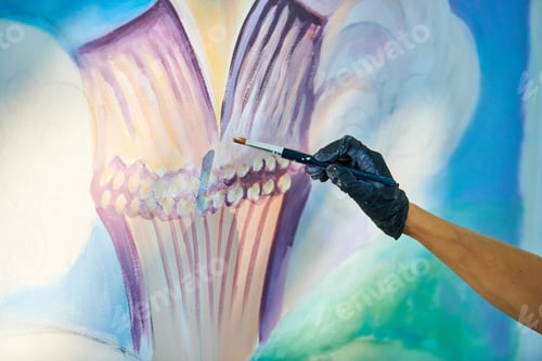 Preview: Girl artist hand holds paint brush and draws surreal fairy tale portrait on white canvas