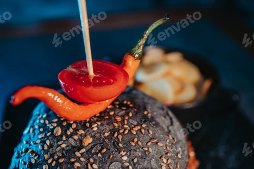 Preview: Selective focus shot of a tasty black burger with french fries in a bowl
