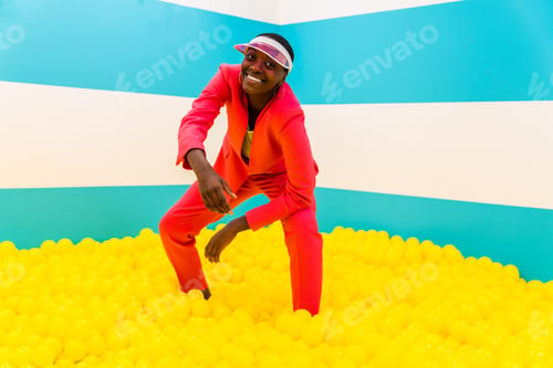 Vista previa: Beautiful young woman posing and having fun inside a rainbow box room