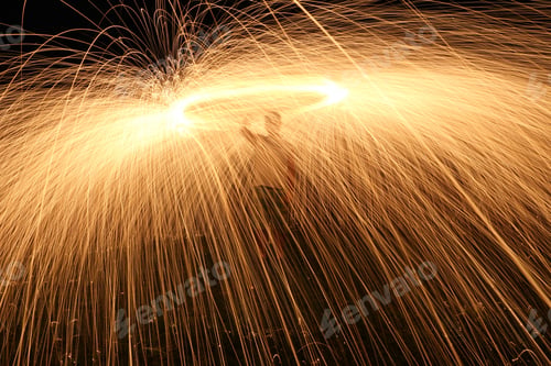 Preview: Closeup shot of a man making sparks in the night