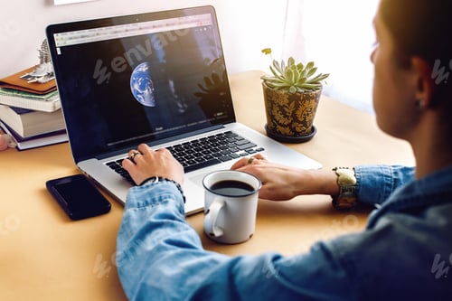 Preview: stylish girl with coffee on background of laptop map