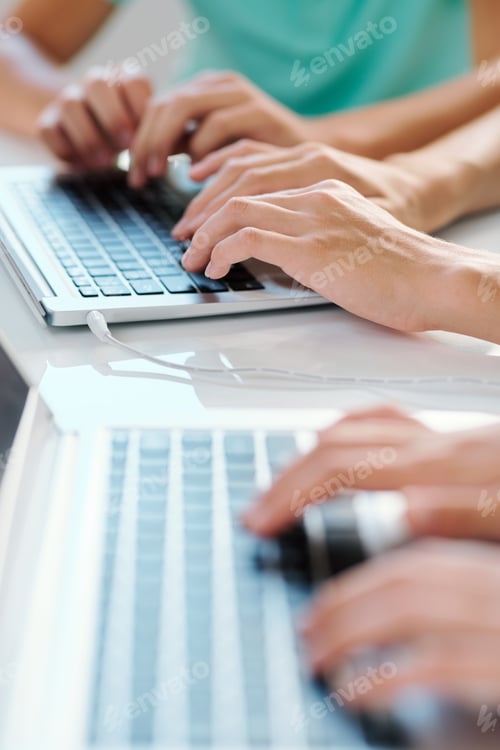 Preview: One of young contemporary co-workers or classmates typing on laptop keypad