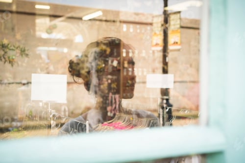 Preview: Reflection of woman in shop window