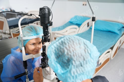 Preview: Ophthalmologist examining the eyeball of patient before surgery