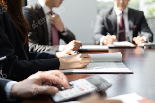 Preview: A Japanese businessperson having a meeting in a brightly lit conference room.