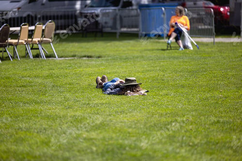 Preview: Girl with a hat on e face, laying on the meadow a in a sunny, nice day