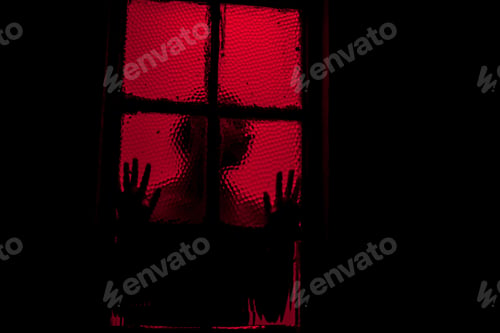 Preview: Silhouette of person pressing against window in room with red light. Ominous image