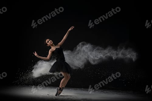 Preview: Emotional Southeast Asian ballet dancer in a black dress performing a move on a black background