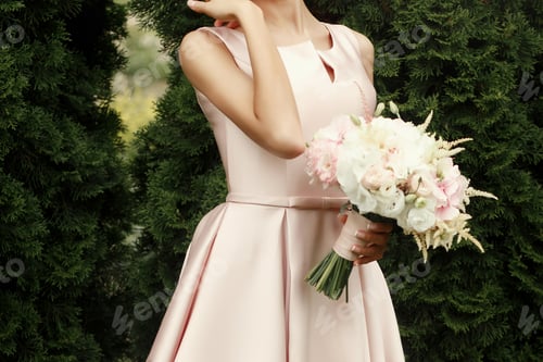 Preview: bride holding wedding bouquet of pink and white flowers in hands with luxury rings