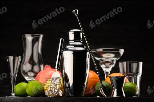 Preview: shining shaker for preparing alcohol drink, empty glasses and ripe fruits on table isolated on black