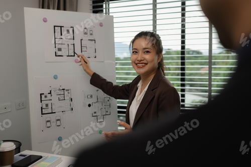 Preview: an architect is working in the office with his team, blueprint on the desk, contractor working with