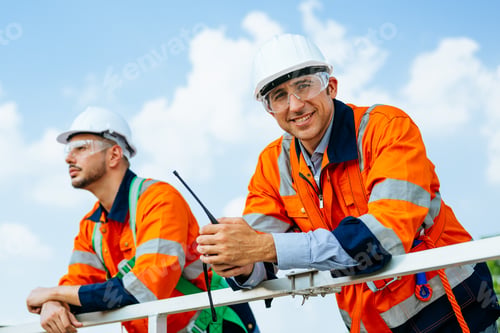 Preview: Professional engineers technicians working at wind turbine farm field