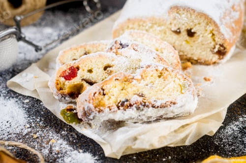 Preview: Christmas traditional fruit bread stollen with dried berries, nuts and powdered sugar