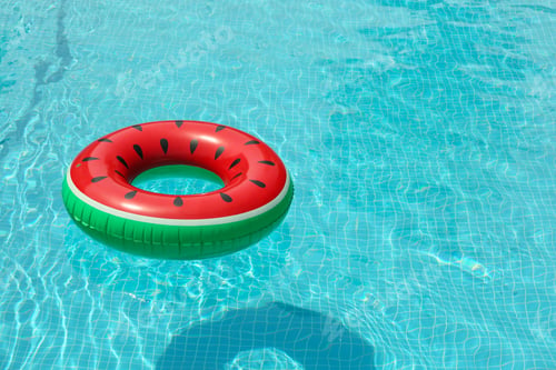 Preview: Inflatable ring floating in pool on sunny day