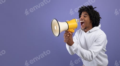 Preview: Emotional black teen guy shouting into megaphone, announcing breaking news over violet background
