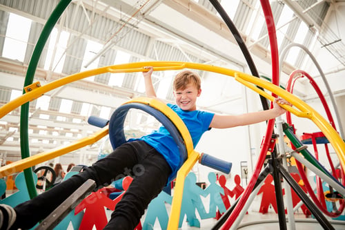 Preview: Young white boy having fun using a human gyroscope