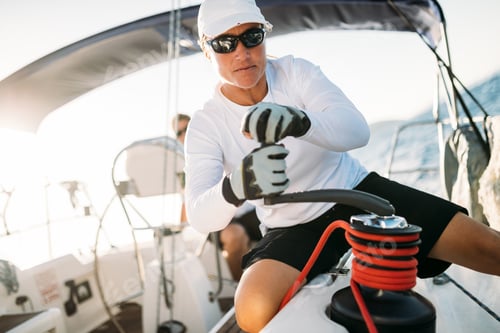 Preview: Attractive strong woman sailing with her boat