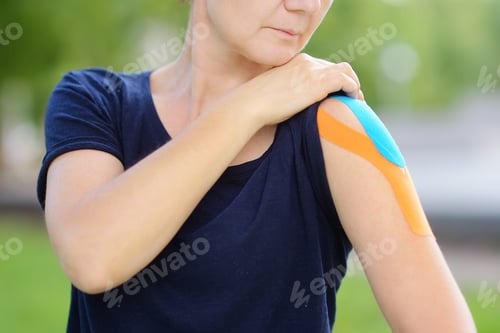 Preview: Woman with kinesio tape on her shoulder. Kinesiology, physical therapy, rehabilitation