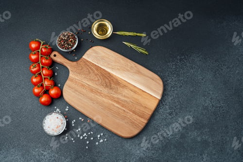 Preview: Cutting board with cherry tomatoes herbs salt and spices on dark background