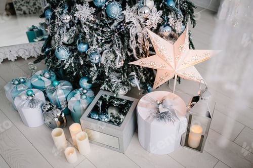 Preview: Decorated Christmas interior. Tree with gifts boxes in a white room.Fir-tree decorated with garlands
