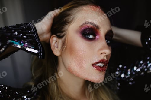 Preview: Glad european girl with purple makeup touching her hair. Pleased white woman posing with serious fa