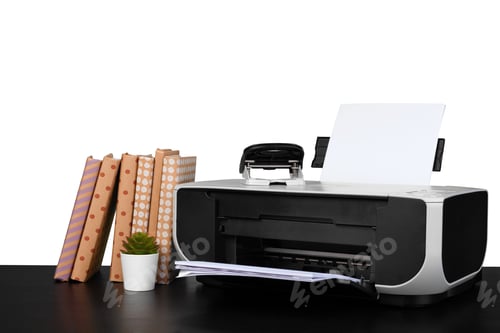 Preview: Printer and stack of books on black table against white background
