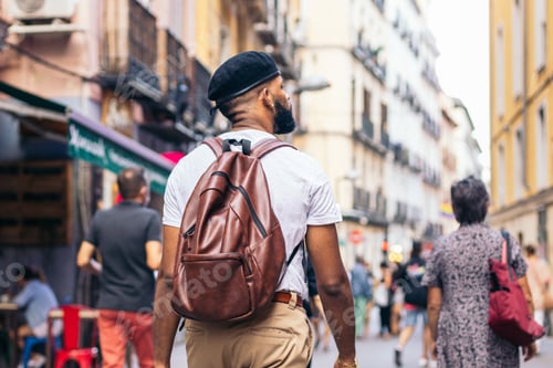 Preview: Stylish black man walking on the city street